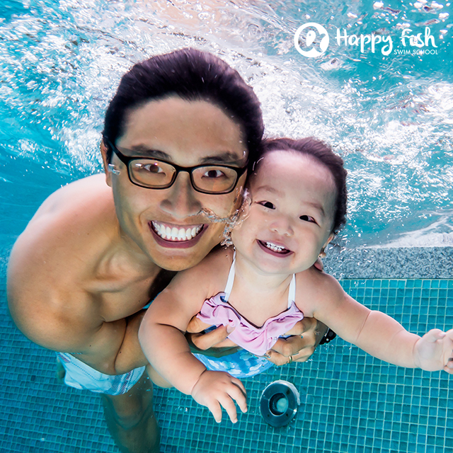 Father and baby swim in pool for children at Wild Wild Wet water theme park Singapore