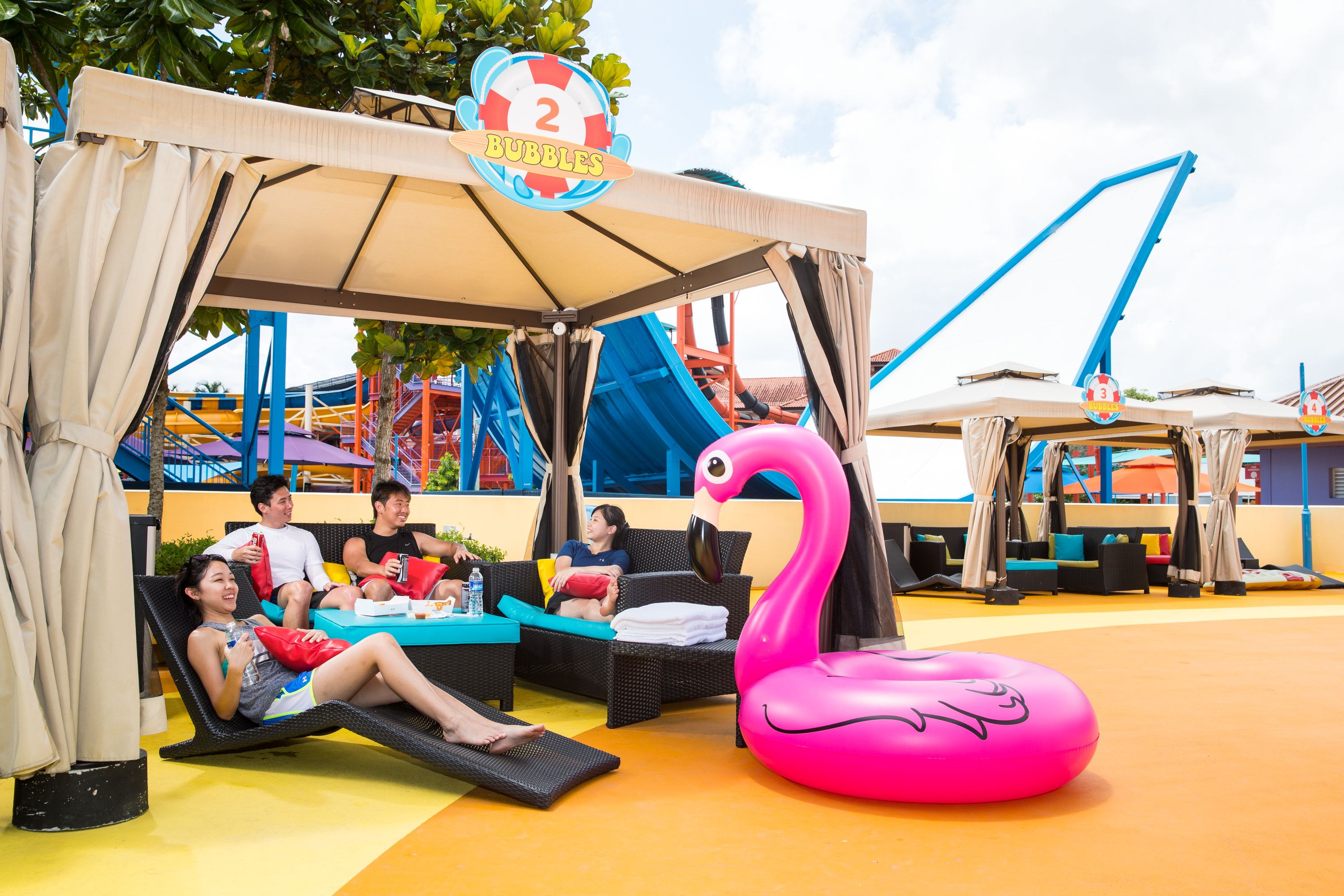 Group of friends relaxs at cabana in Wild Wild Wet water theme park Singapore