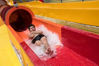 Man plays vortex high speed water slide in Wild Wild Wet water park Singapore