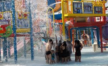 A big group plays professor's water playground in Wild Wild Wet water theme park Singapore