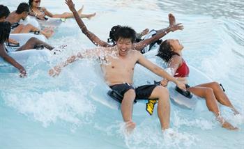 Group enjoys tsunami wave pool in Wild Wild Wet water park Singapore