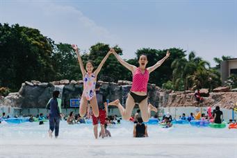 People enjoy tsunami wave pool in Wild Wild Wet water theme park Singapore